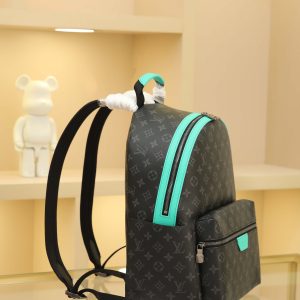 Alternative view of • Monogram Eclipse coated canvas • Full-grain leather trim • Fabric lining • Metal hardware • Double zipper closure • Adjustable shoulder strap • Open side pockets • Zippered front pocket • Interior patch pocket • Handle: Single handle